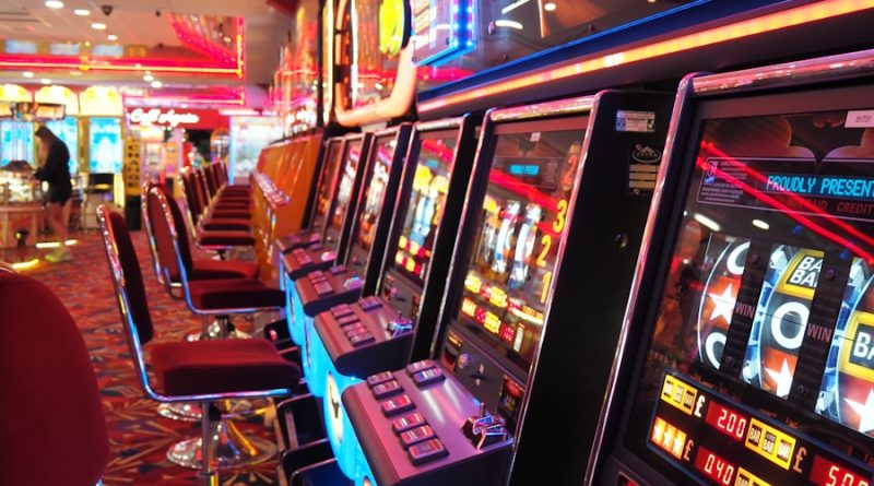 arcade machine with red and white chairs