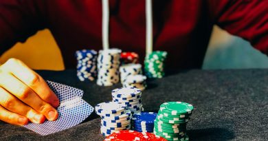 person sitting near poker chips