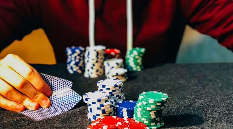 person sitting near poker chips